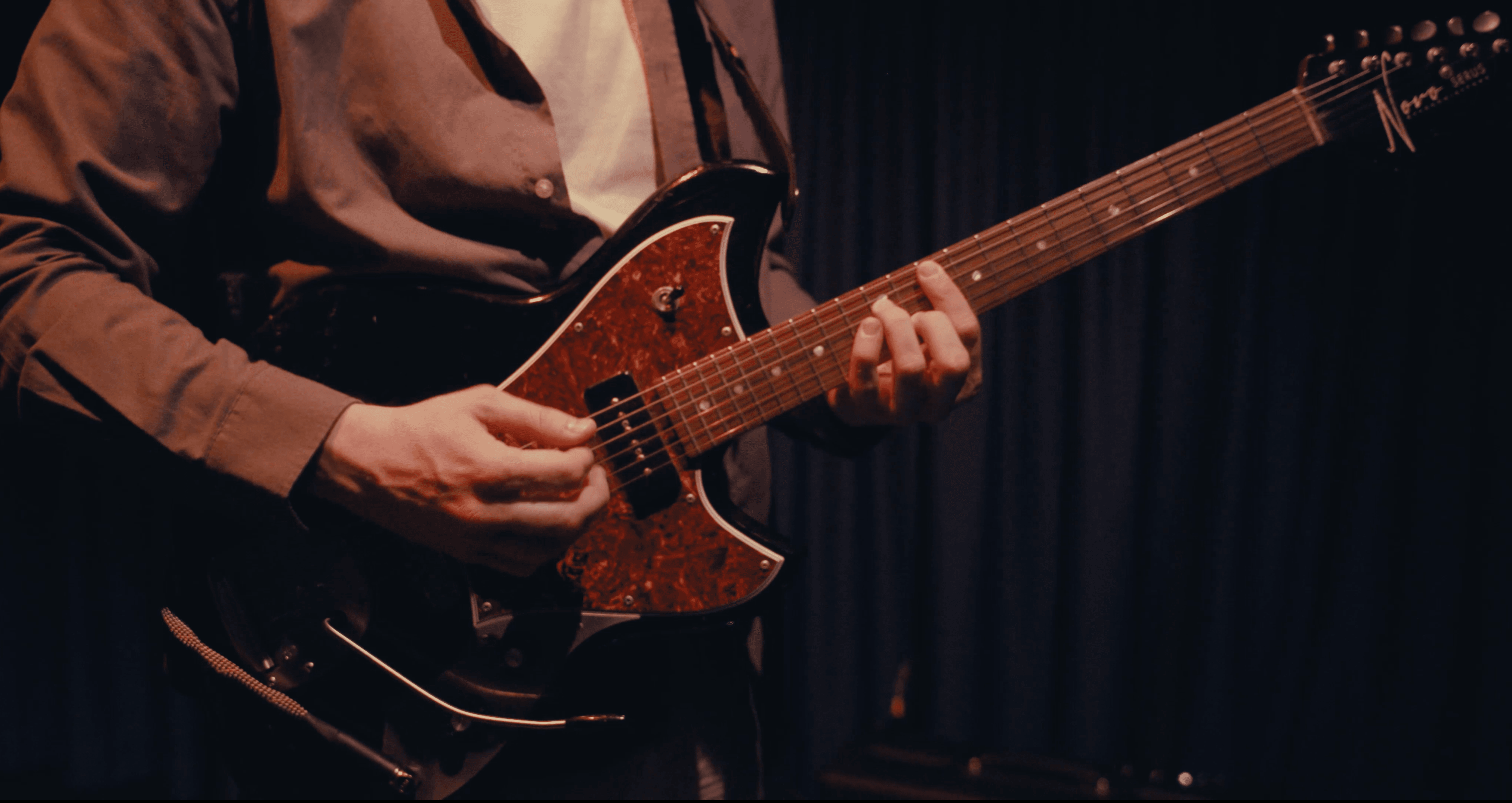 Close-up of Stefano Rana playing guitar