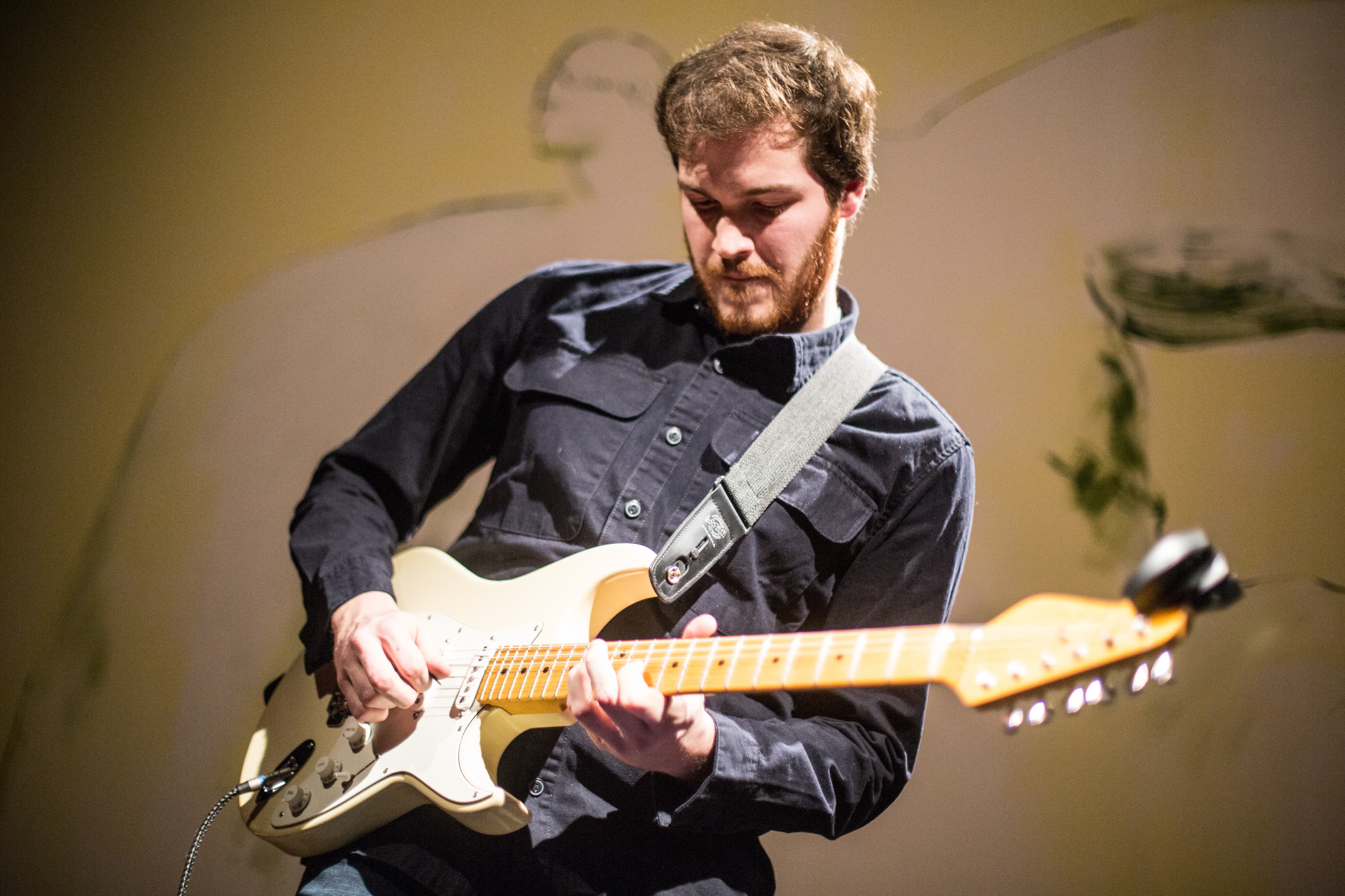 Stefano Rana performing live with a white Stratocaster